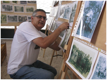 Salvatore Cambria, alle prese con la preparazione di una mostra di foto d'epoca ad Olivarella (Me)
